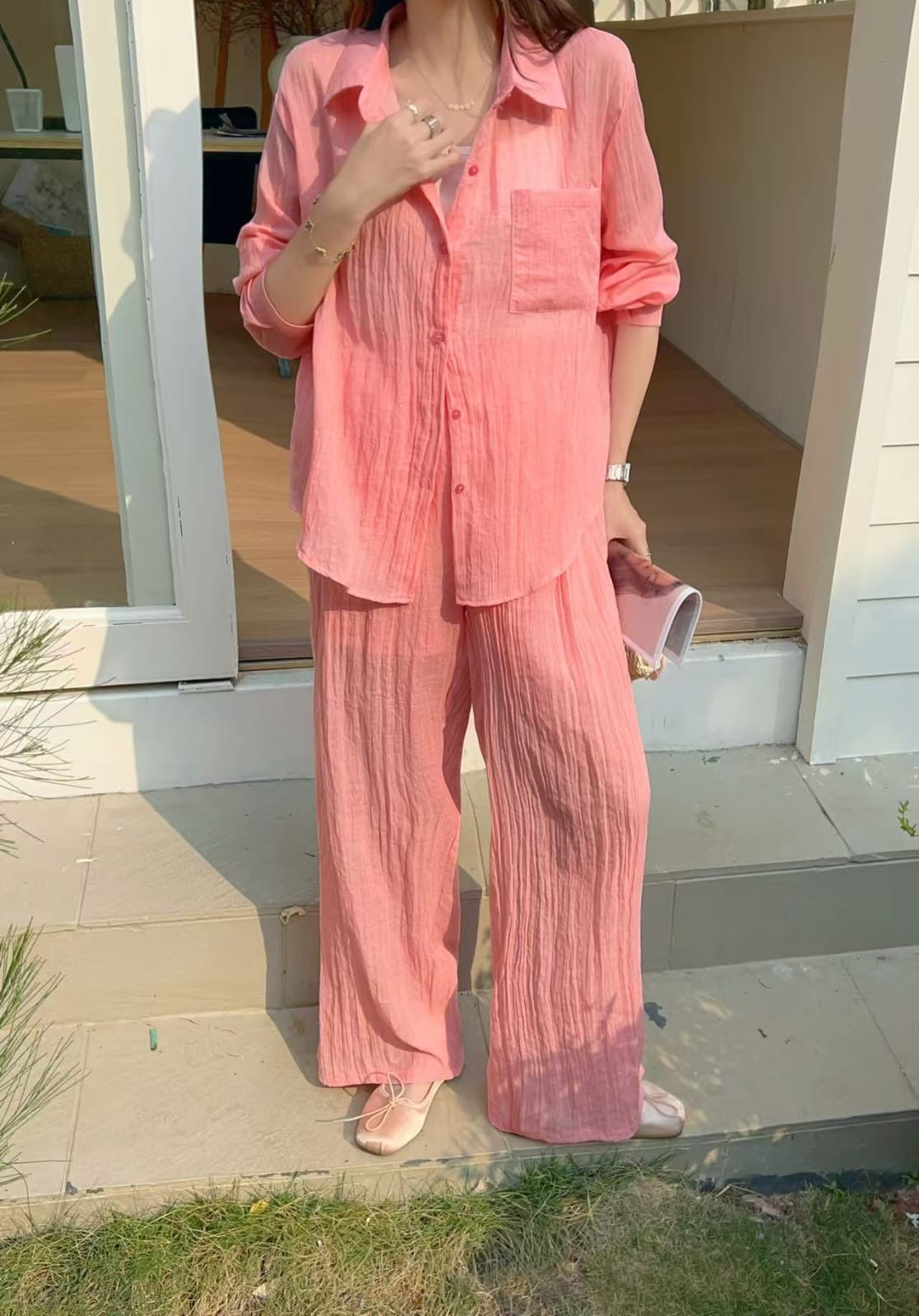Soleil Co-ord Set in Sorbet — coral pink matching shirt and pants set, casual lifestyle shot