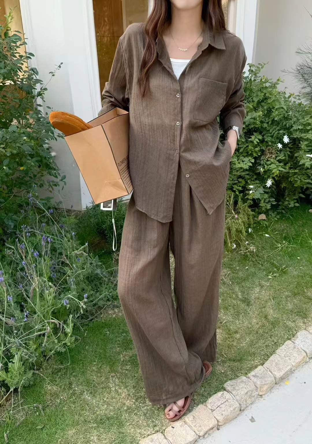 Soleil Co-ord Set in Mocha — warm brown crinkle cotton shirt and wide-leg trousers, outdoor garden setting