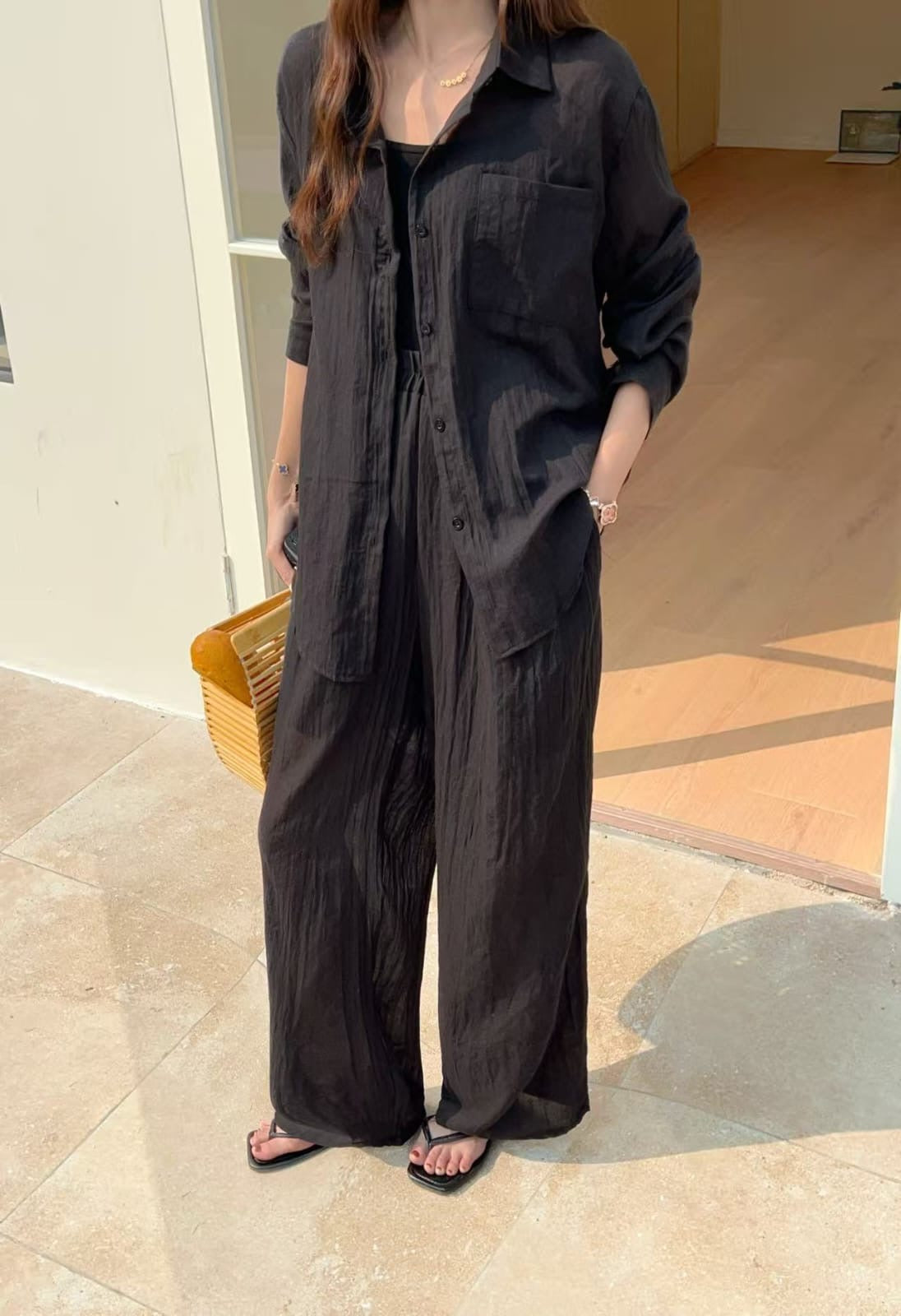 Soleil Co-ord Set in Onyx — black crinkle cotton shirt and wide-leg pants, minimal outdoor setting