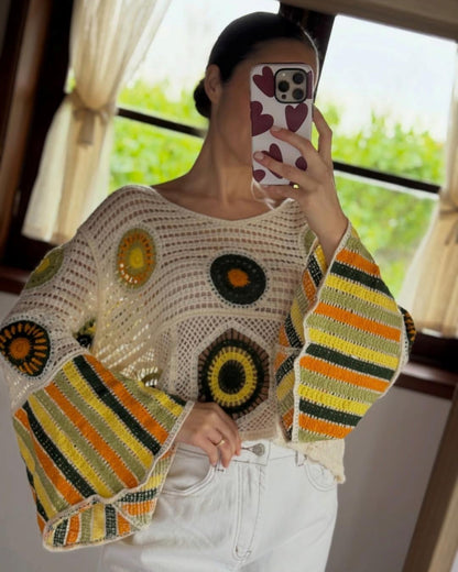 The Soleil Mandala Crochet Top in Meadow — green and yellow circular motifs with striped bell sleeves