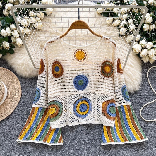 Close-up of hand-crocheted mandala medallion detailing on open-knit ivory base