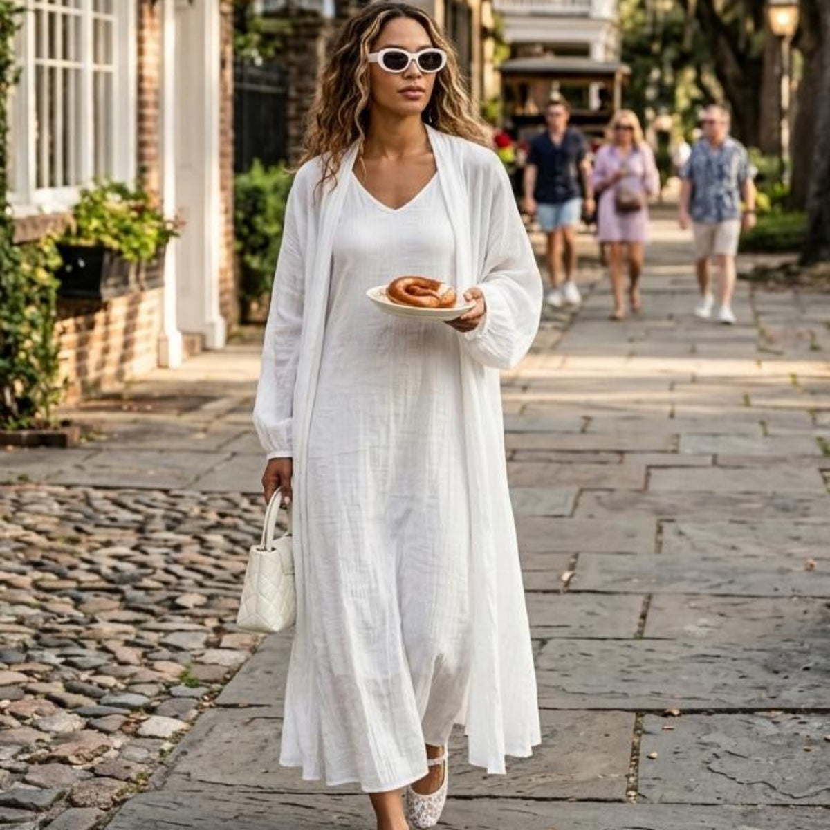 Zephyr Co-ord Set in Blanc — white lined dress with open shrug, cobblestone street setting