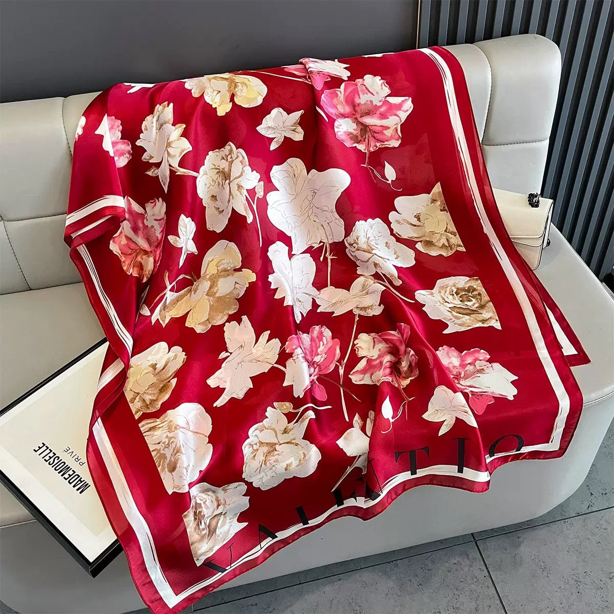 Red floral patterned blanket on a white chair