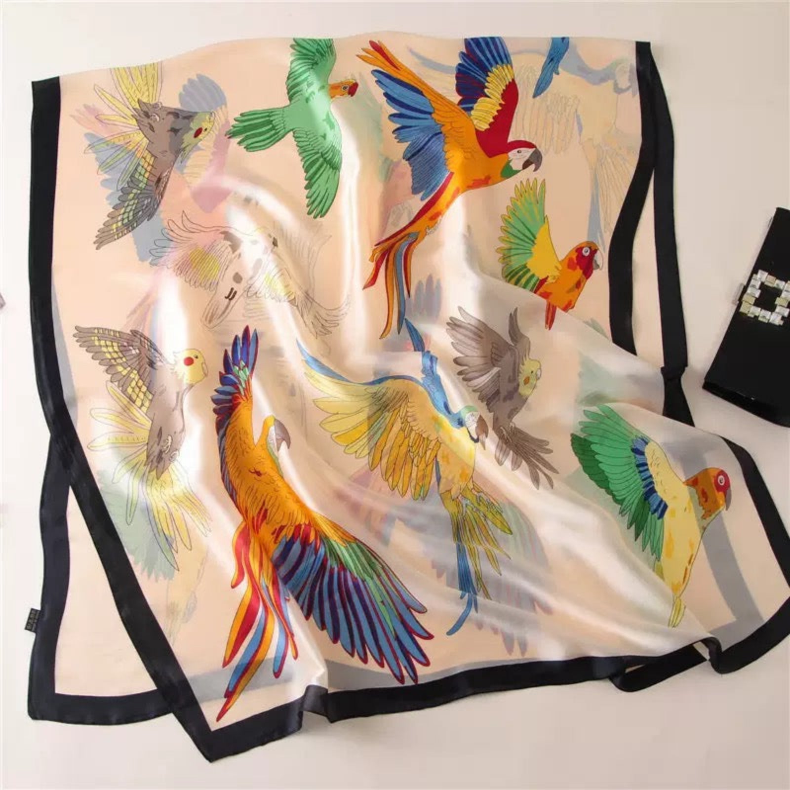 Silk scarf with colorful parrot design on a white background