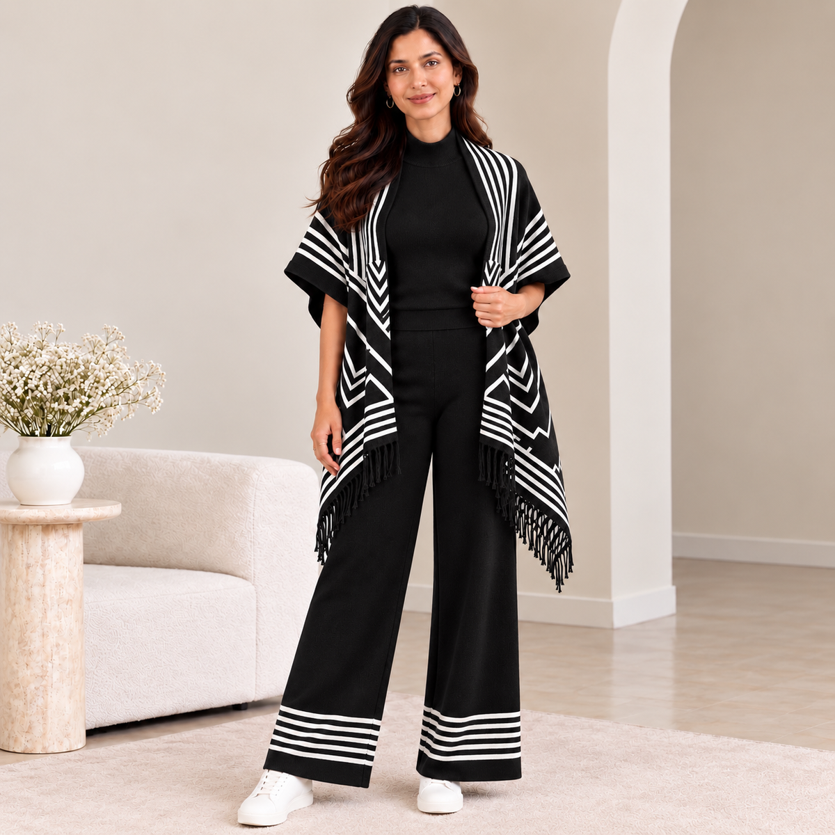 Woman wearing black 3-piece knit co-ord set with chevron fringe cardigan