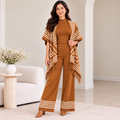 Woman wearing camel 3-piece knit co-ord set with fringe-trim cardigan and wide-leg pants