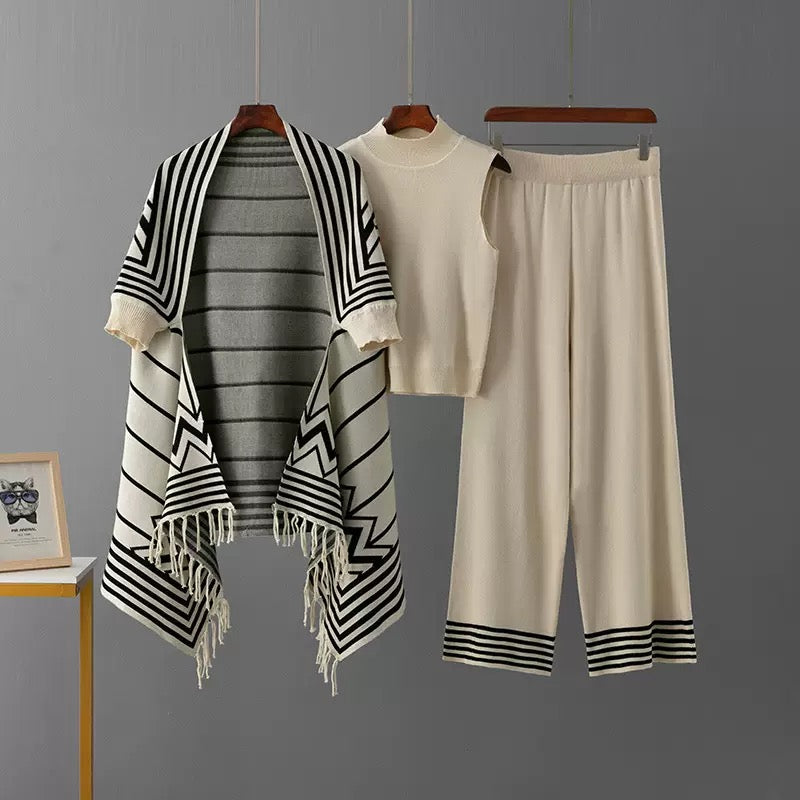 Ivory 3-piece knit co-ord set laid flat showing fringe cardigan, top, and pants
