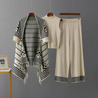 Ivory 3-piece knit co-ord set laid flat showing fringe cardigan, top, and pants
