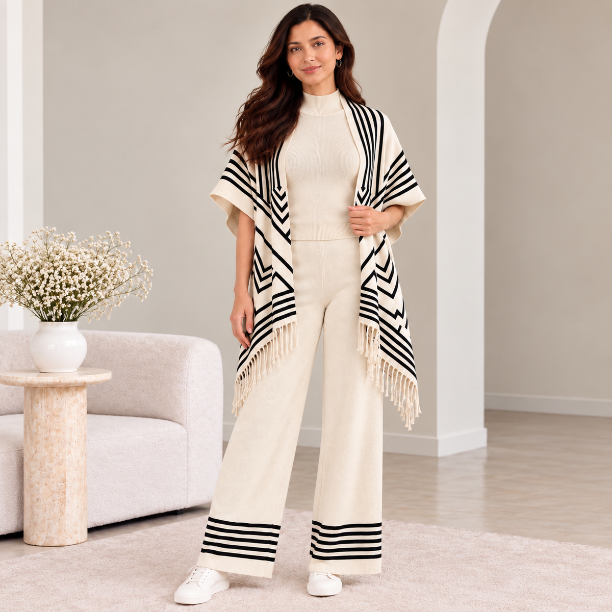 Woman wearing ivory 3-piece knit co-ord set with black chevron fringe cardigan