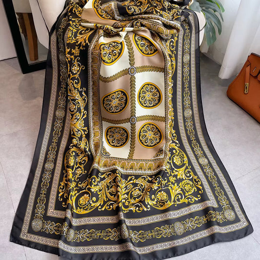Flat lay of baroque print silk scarf showing ornate medallion pattern and Greek key border detail