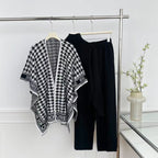 Black knit top and wide-leg pants with monochrome houndstooth wrap