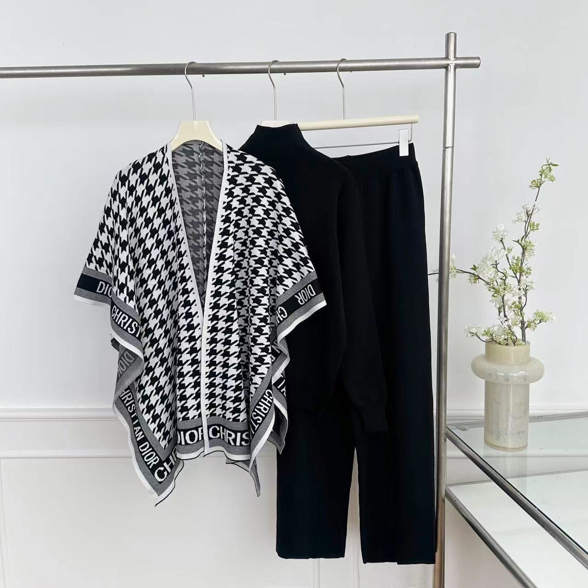 Black knit top and wide-leg pants with monochrome houndstooth wrap
