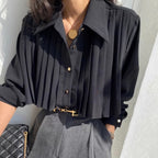 Black pleated cape collar polyblend shirt front view - woman wearing elegant button-down blouse with gold buttons
