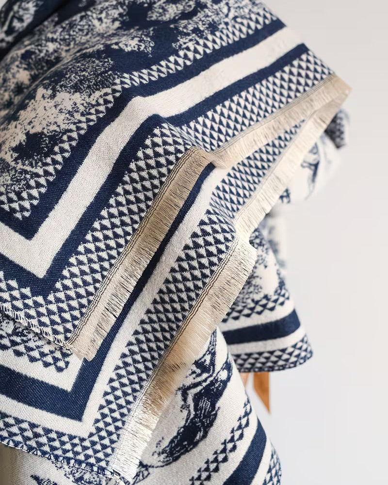 Close-up of The Bleu Jardin Cashmere Wrap showing soft faux cashmere fabric texture with detailed blue garden botanical floral motif print
