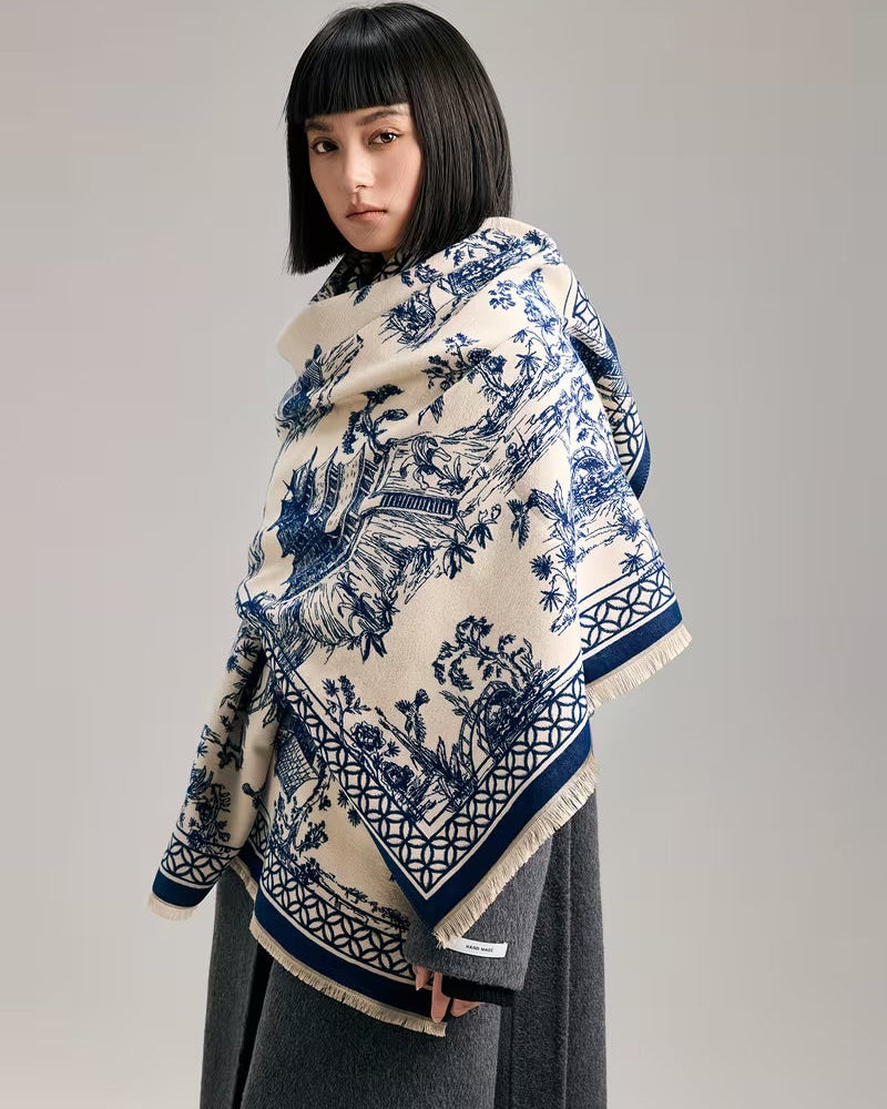 The Bleu Jardin Cashmere Wrap laid flat displaying full romantic blue botanical garden floral print on soft faux cashmere base
