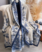The Blue Willow Reversible Wrap showing primary side with heritage blue and white chinoiserie willow botanical print on faux cashmere fabric
