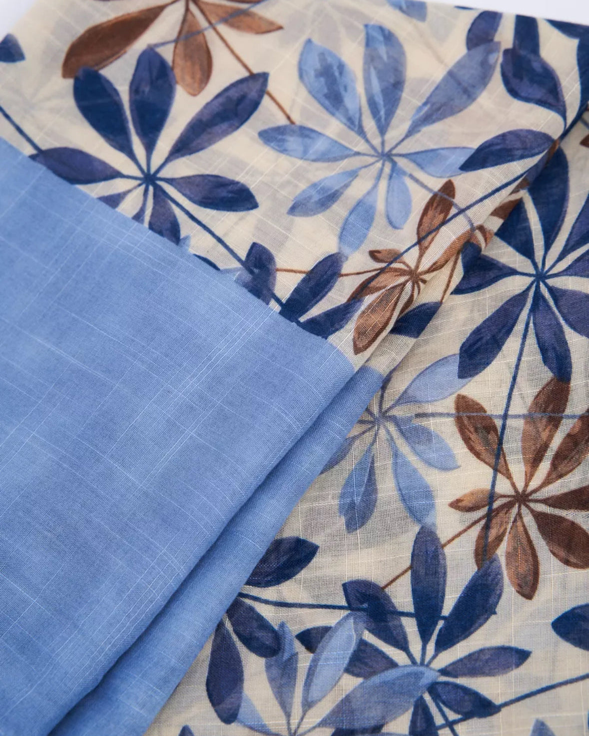 The Bluebell Meadow Linen Stole laid flat displaying full bluebell botanical print in blue violet tones on natural linen fabric
