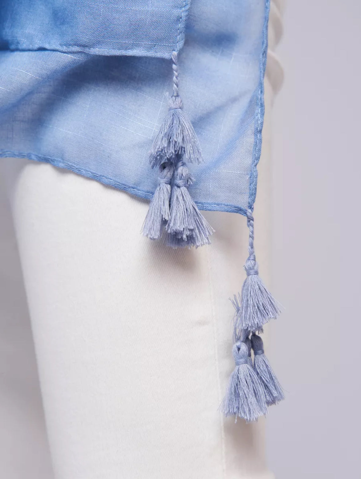 Close-up of The Bluebell Meadow Linen Stole showing natural linen fabric texture with detailed soft bluebell botanical print in blue and violet tones
