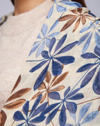 The Bluebell Meadow Linen Stole worn over shoulders showing bluebell floral print and natural linen texture drape
