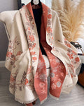 The Blush Botanica Reversible Wrap showing primary blush pink side with soft botanical floral motifs on faux cashmere fabric
