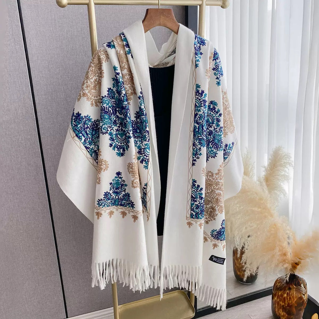 Bohemian Elegance Winter Scarf with Fringe draped as cape on mannequin showing white faux cashmere with blue teal and gold paisley embroidery and fringe edge
