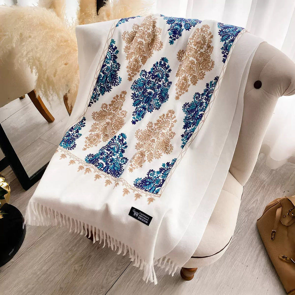 Bohemian Elegance Winter Scarf with Fringe laid flat showing full cobalt blue teal and golden beige embroidered paisley mandala pattern on white faux cashmere

