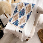 Bohemian Elegance Winter Scarf with Fringe laid flat showing full cobalt blue teal and golden beige embroidered paisley mandala pattern on white faux cashmere
