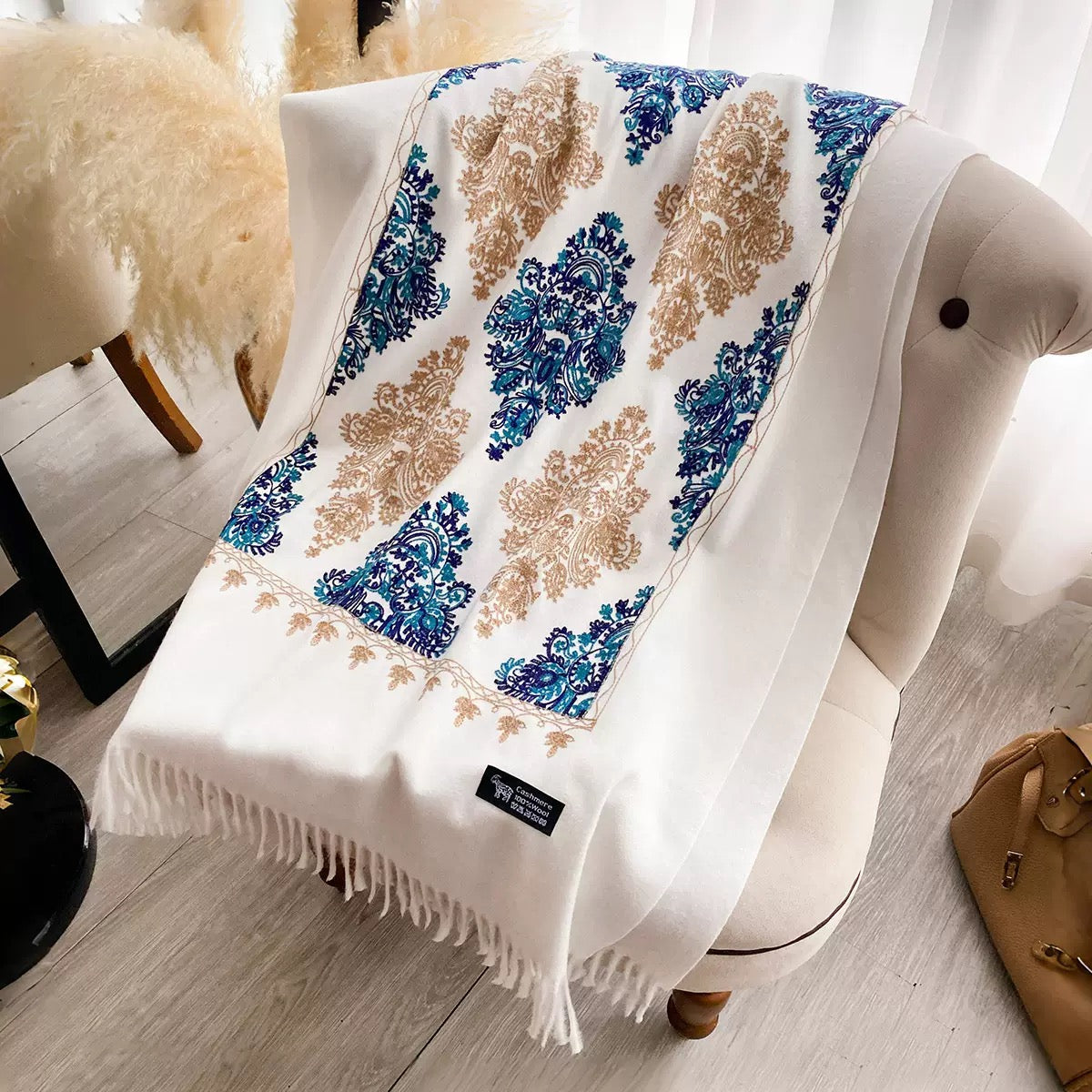 Bohemian Elegance Winter Scarf with Fringe laid flat showing full cobalt blue teal and golden beige embroidered paisley mandala pattern on white faux cashmere
