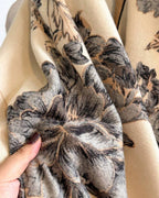 Close-up of Botanical Bloom Cashmere-Feel Wrap showing soft faux cashmere fabric texture with detailed vintage botanical floral motif print
