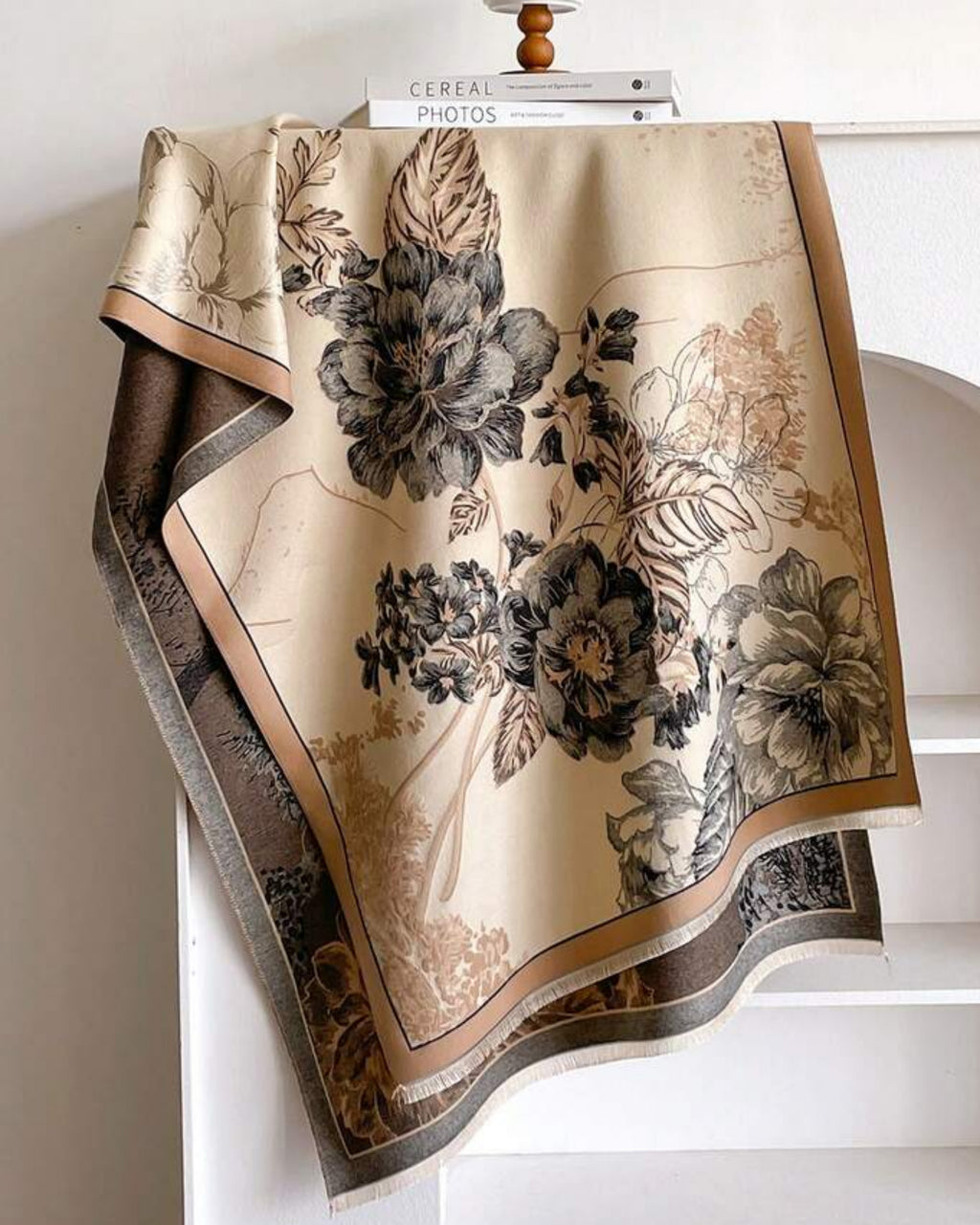 Botanical Bloom Cashmere-Feel Wrap laid flat showing full vintage botanical floral print in tonal shades on warm neutral beige faux cashmere base
