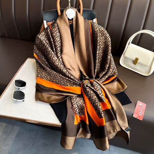 Brown beige orange geometric print silk scarf styled with handbag and accessories - Greek key border luxury scarf