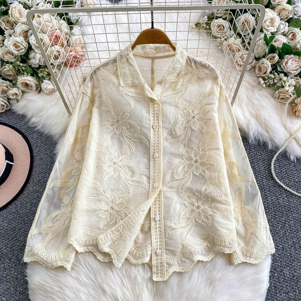 Camellia Bloom Embroidered Linen Shirt in ivory displayed on hanger showing full floral embroidery