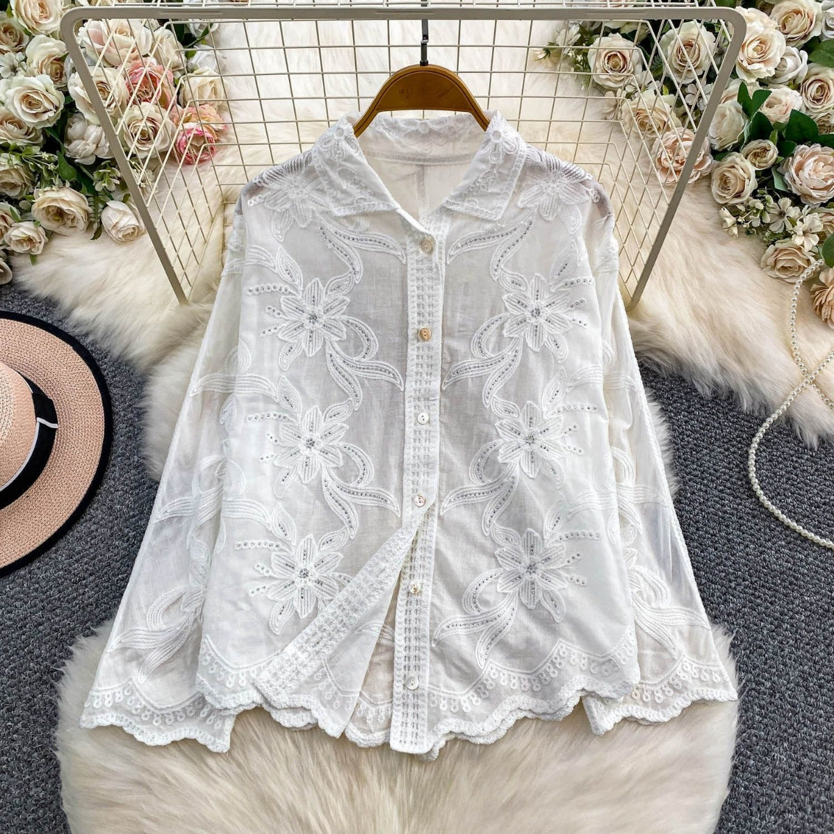 Camellia Bloom Embroidered Linen Shirt in white displayed on hanger showing full floral embroidery