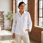 Woman wearing Camellia Bloom Embroidered Linen Shirt in white with floral embroidery detail