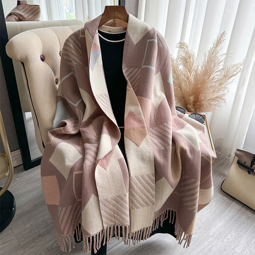 Chic Reversible Winter Poncho Shawl draped over mannequin showing geometric print in dusty rose beige and cream with fringe edge
