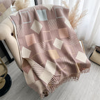 Chic Reversible Winter Poncho Shawl laid flat showing full geometric square print in dusty rose beige and cream tones with fringe edges
