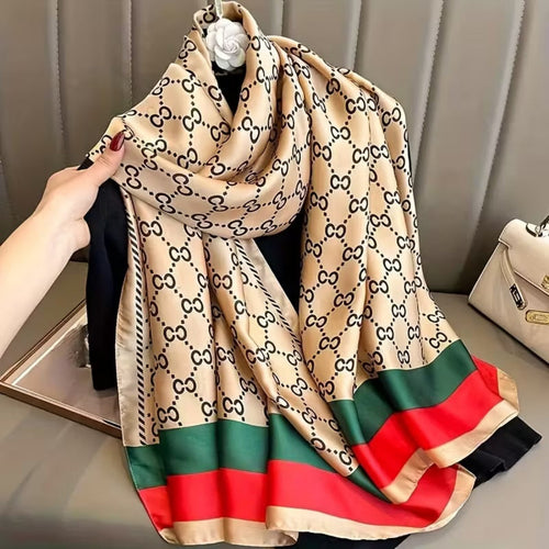 Classic Monogram Printed Silk Stole showing heritage black monogram pattern on beige satin silk with bold red and green statement border in 180x90cm format

