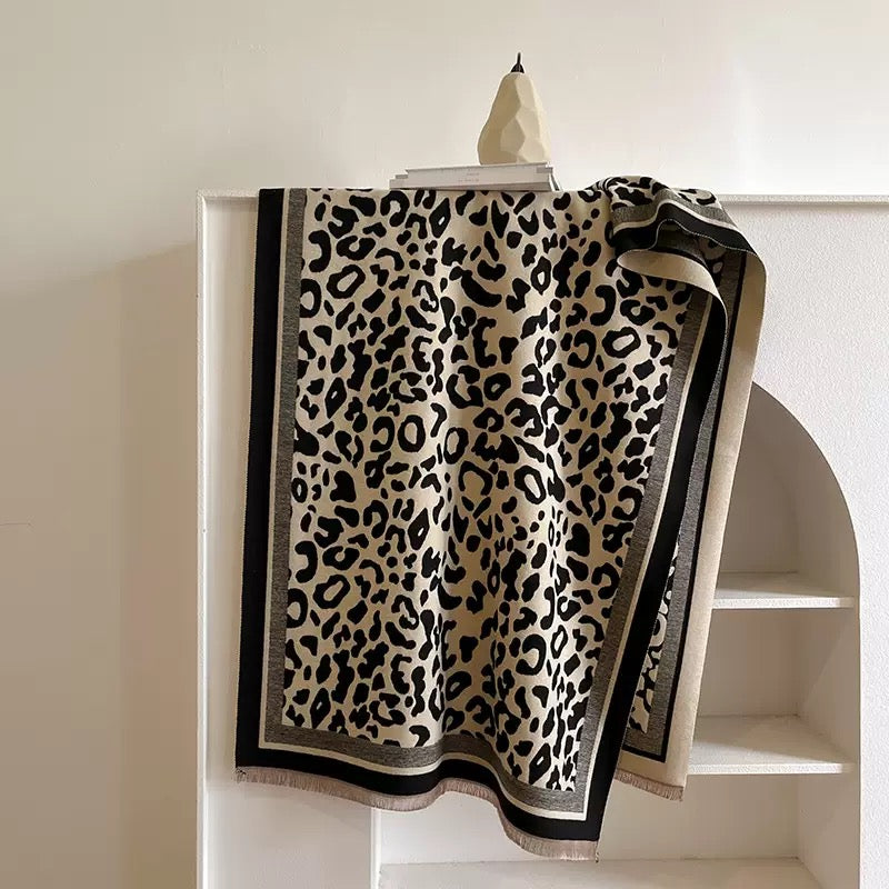 Classic Safari Leopard Knit Wrap featuring an all-over leopard print with contrasting black border and soft knit texture.