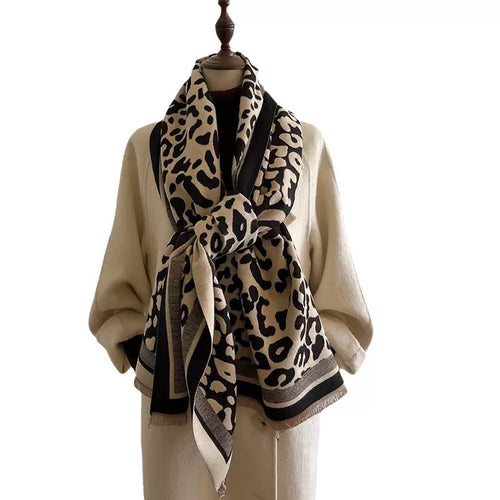Classic Safari Leopard Knit Wrap styled in a knotted neck wrap with bold leopard print and fringed edges