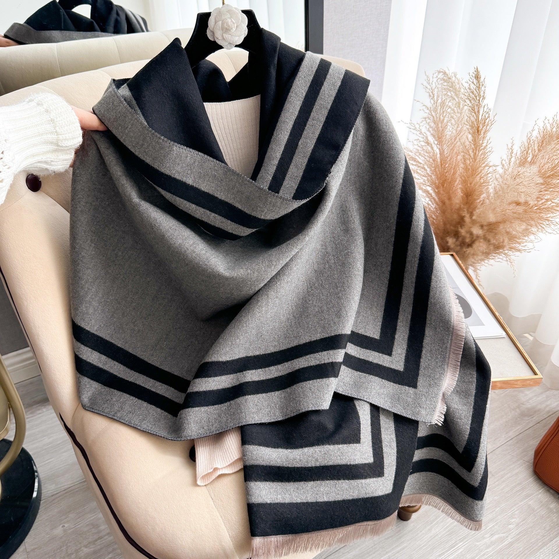 Cozyzone Classic Striped Knit Scarf Shawl draped and styled showing full black and grey jacquard striped pattern on faux cashmere

