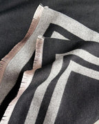 Close-up of Cozyzone Classic Striped Knit Scarf Shawl showing jacquard woven stripe texture detail in black and grey faux cashmere fabric
