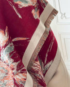 Close-up of Crimson Dahlia Floral Cashmere-Blend Wrap showing jacquard woven fabric texture with dimensional claret dahlia floral motif on cream faux cashmere

