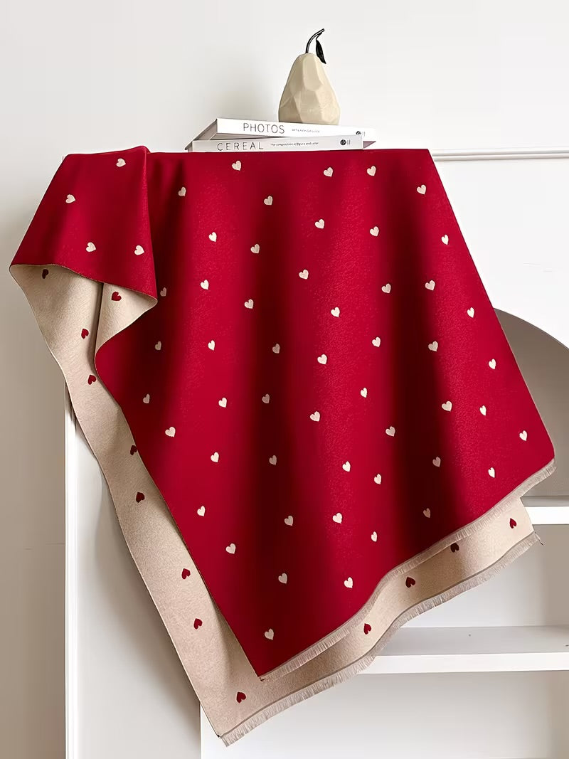 The Crimson Hearts Cashmere Wrap laid flat displaying full crimson heart motif print pattern on soft deep red faux cashmere base
