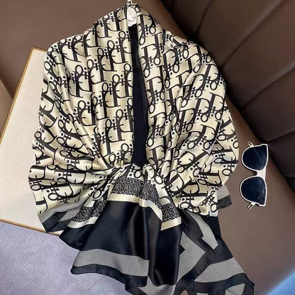 Designer logo print imitation silk stole in beige and black - luxury scarf styled with sunglasses