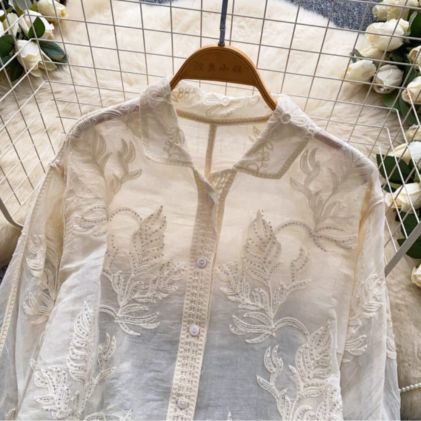 Front detail of embroidered linen cotton shirt showing silver accents, lace placket and collar