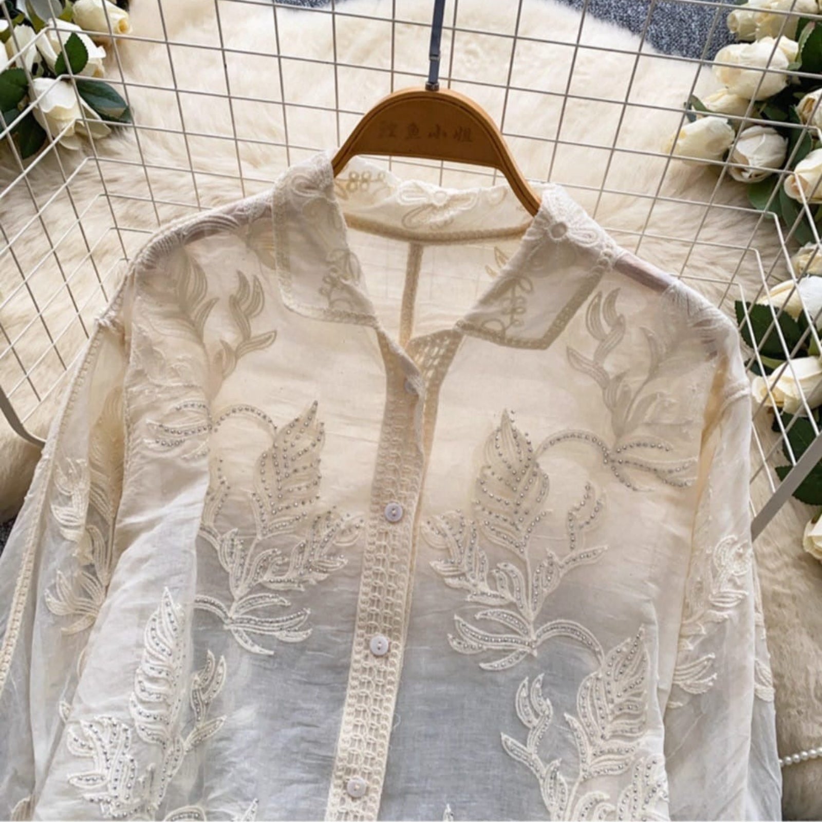 Front detail of embroidered linen cotton shirt showing silver accents, lace placket and collar