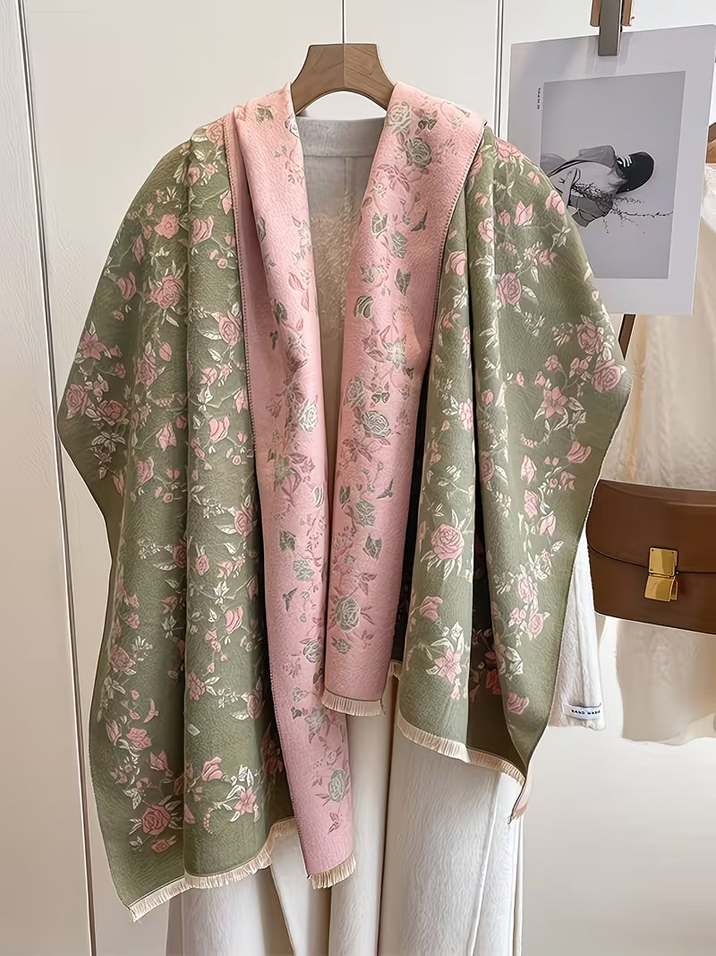 Enchanted Rose Two-Tone Fringed Wrap draped open as a cape showing sage green exterior and dusty rose interior with rose floral print on both sides
