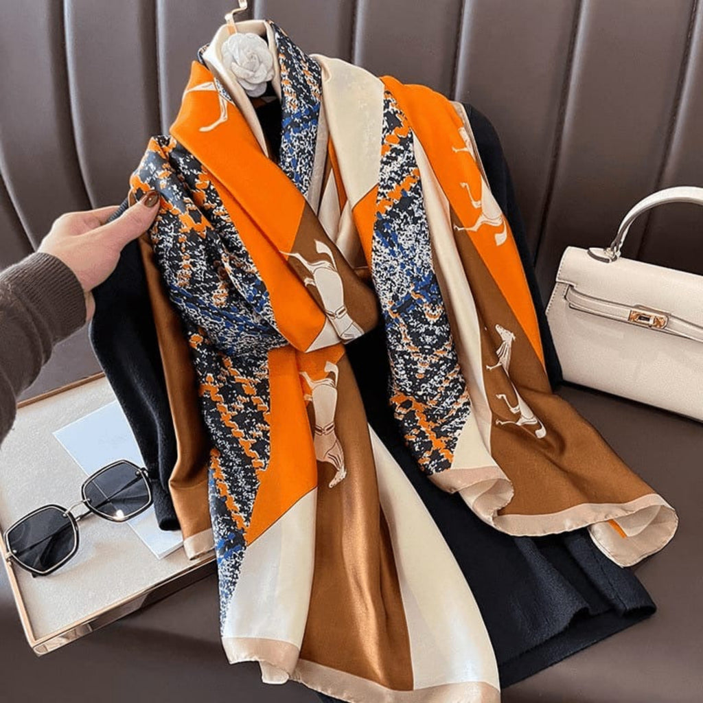 Equestrian print silk scarf draped on mannequin - orange beige horse scarf styling with accessories