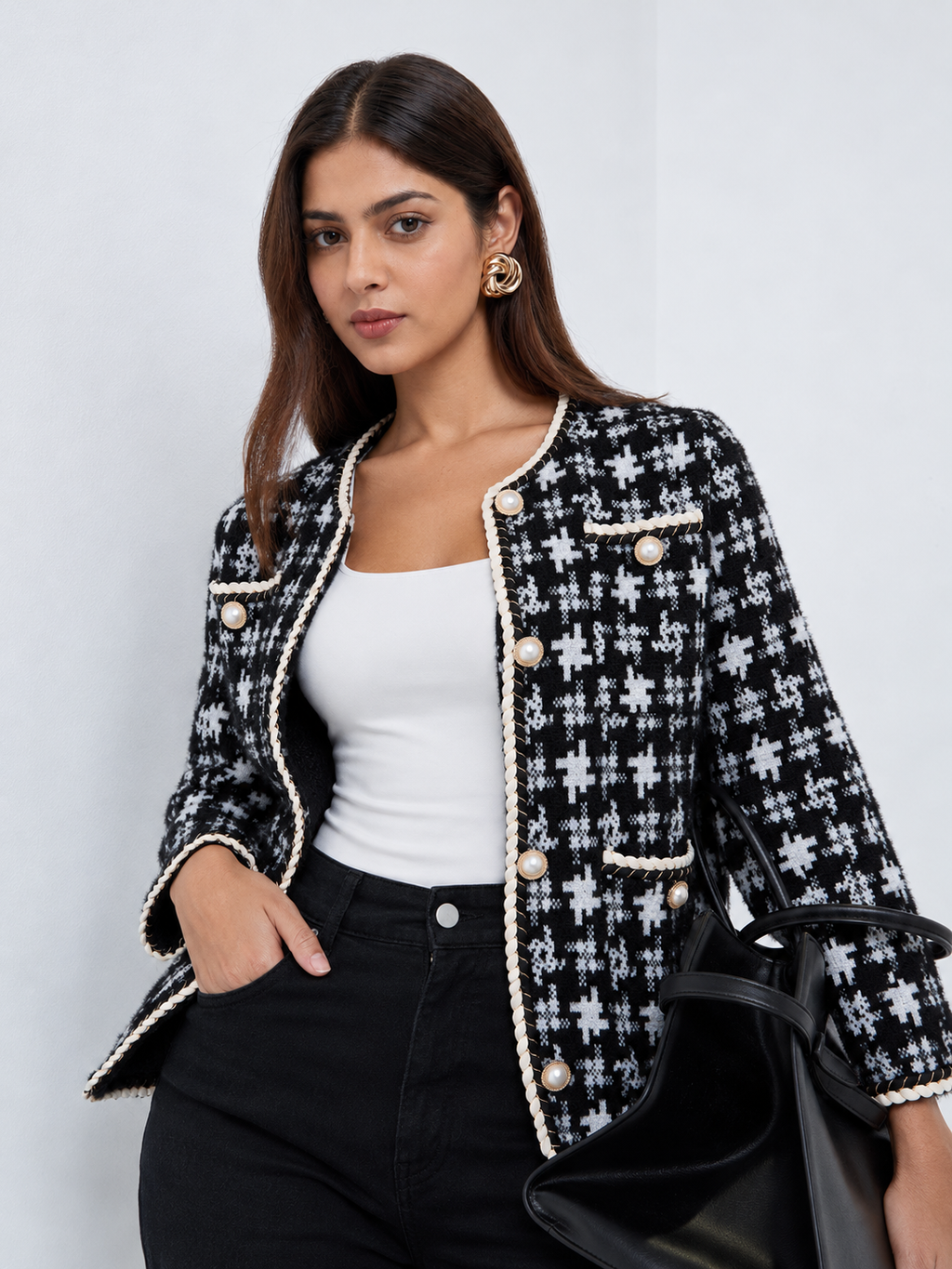 Women’s black and white geometric knit cardigan with pearl-effect buttons and braided trim by Westery Fashion House.