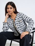 Ivory and black geometric knit cardigan for women with pearl-effect buttons, front pockets and contrast braided trim.